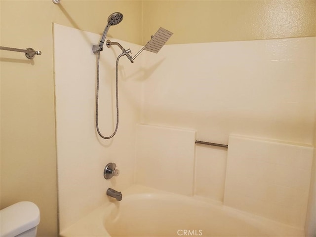 bathroom featuring toilet and tub / shower combination