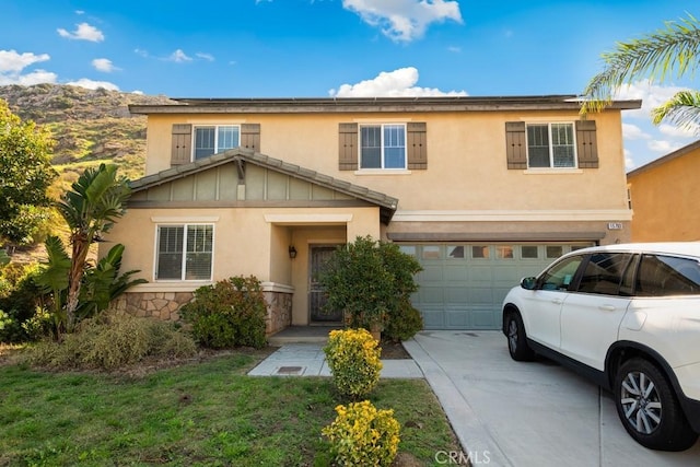 15793 Willow Dr, Fontana, CA 92337 - view of front of home featuring an attached garage, concrete driveway, stone siding, and stucco siding