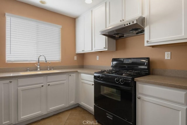 kitchen with white cabinetry, gas stove, under cabinet range hood, and a sink