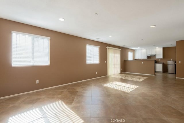 15793 Willow Dr, Fontana, CA 92337 - unfurnished living room with recessed lighting and light tile patterned floors