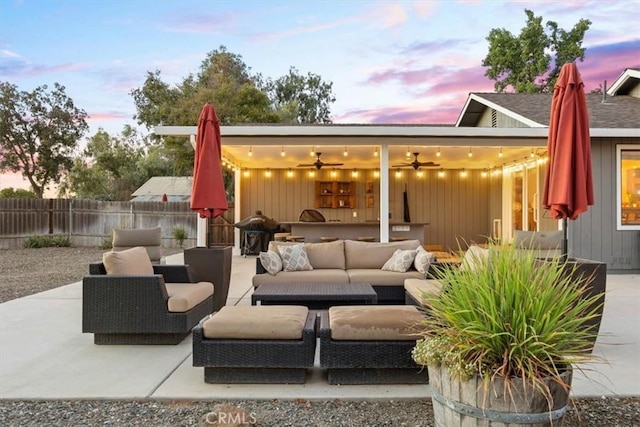view of patio with an outdoor hangout area, a ceiling fan, and fence