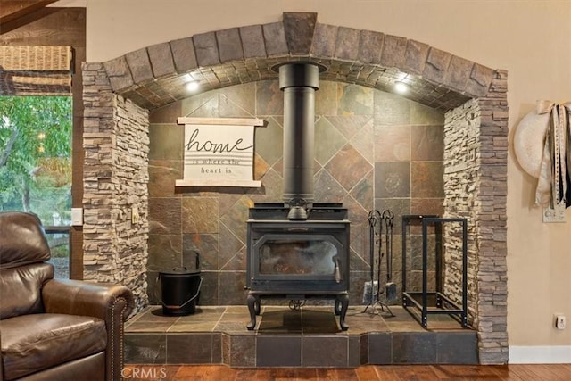 room details featuring wood finished floors and a wood stove