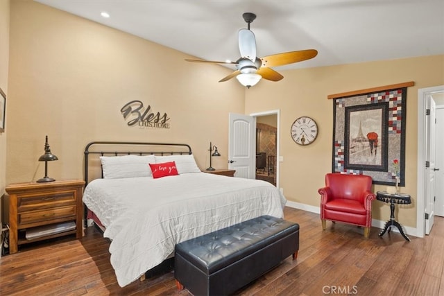 bedroom featuring a ceiling fan, baseboards, and wood finished floors
