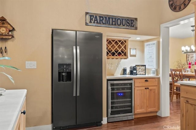 kitchen with beverage cooler, light countertops, an inviting chandelier, stainless steel fridge, and dark wood-style flooring