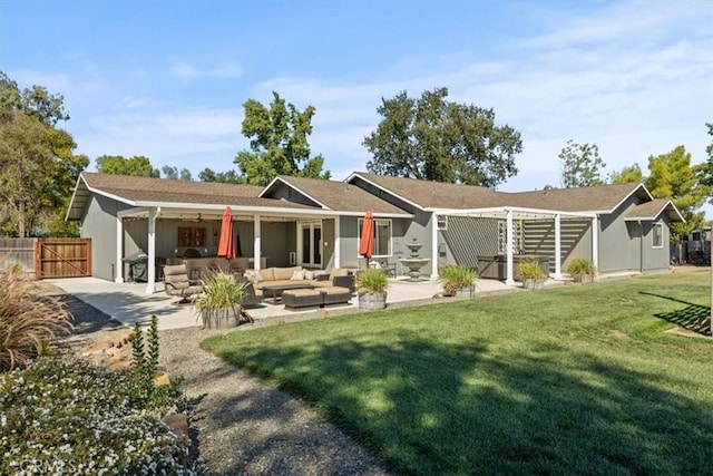 back of house featuring outdoor lounge area, a patio, fence, and a lawn