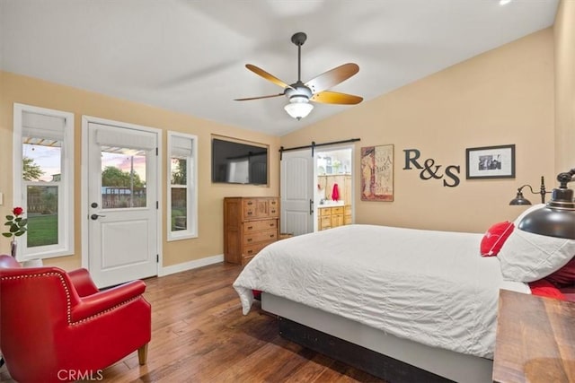 25050 Massachussetts Ave, Corning, CA 96021 - bedroom featuring wood finished floors, vaulted ceiling, a ceiling fan, and a barn door
