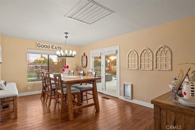 dining area featuring visible vents, a healthy amount of sunlight, and hardwood / wood-style flooring