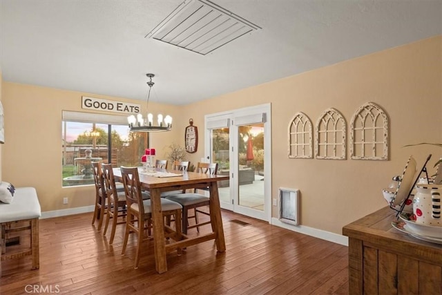 25050 Massachussetts Ave, Corning, CA 96021 - dining space featuring wood finished floors, healthy amount of natural light, and a chandelier