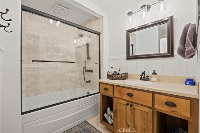 bathroom with bath / shower combo with glass door and vanity