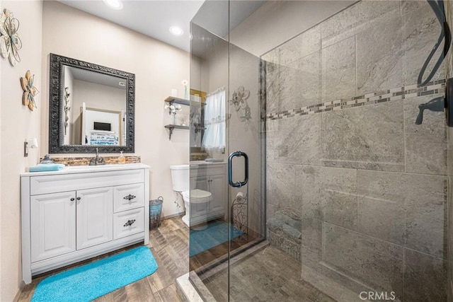 full bath with vanity, toilet, recessed lighting, wood finished floors, and a stall shower
