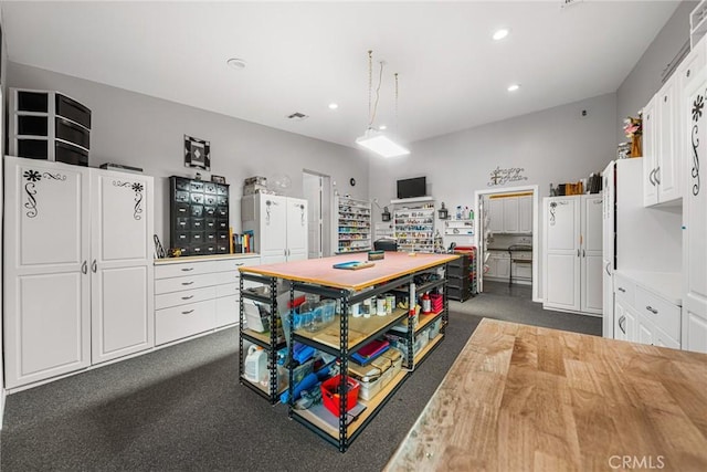 kitchen featuring white cabinets, recessed lighting, dark carpet, and light countertops