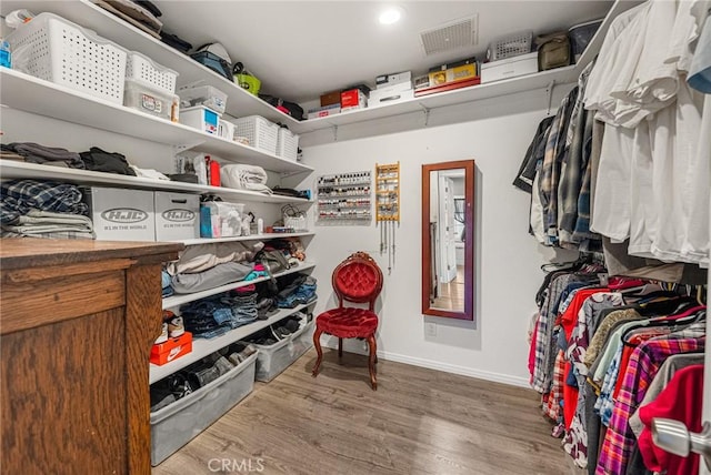 spacious closet featuring wood finished floors and visible vents