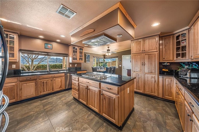 6116 Panorama St, Joshua Tree, CA 92252 - kitchen with appliances with stainless steel finishes, a center island, a sink, glass insert cabinets, and brown cabinetry