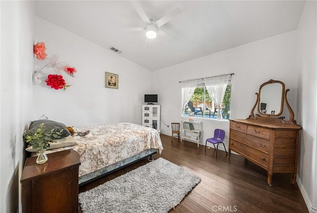 bedroom with visible vents, lofted ceiling, wood finished floors, baseboards, and a ceiling fan