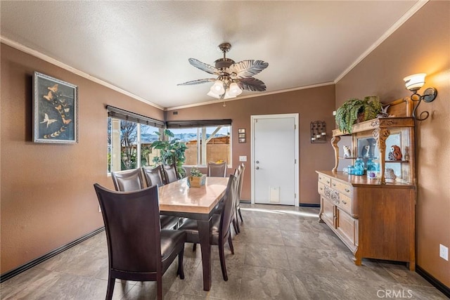 dining space with baseboards, ornamental molding, and ceiling fan