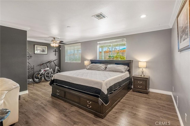 bedroom featuring baseboards, crown molding, and visible vents