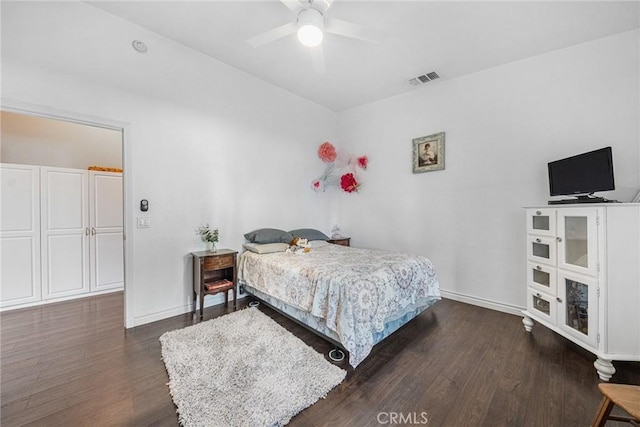 bedroom with baseboards, visible vents, ceiling fan, and dark wood-type flooring