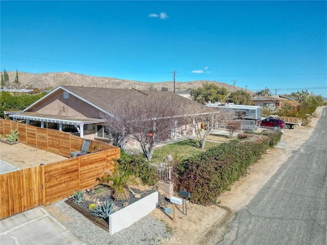 view of side of property featuring fence