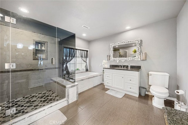 full bath with vanity, a garden tub, visible vents, toilet, and a shower stall