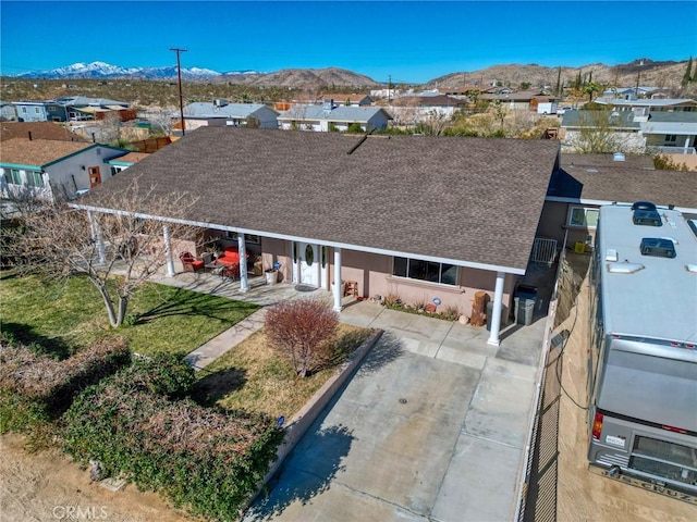 6116 Panorama St, Joshua Tree, CA 92252 - view of front of home featuring a mountain view, roof with shingles, a residential view, and stucco siding