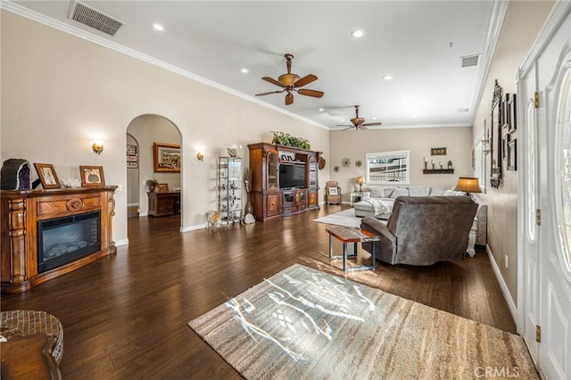 living room featuring arched walkways, ceiling fan, recessed lighting, and visible vents