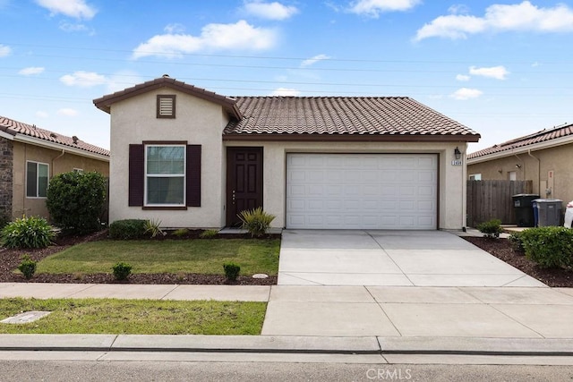 view of front of home with a front yard, driveway, stucco siding, a garage, and a tiled roof