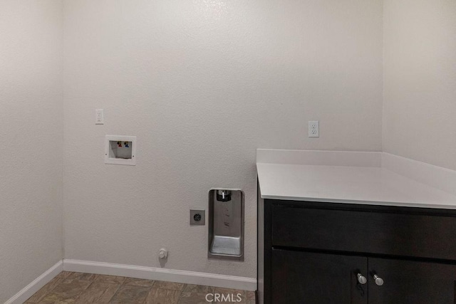 clothes washing area with hookup for a gas dryer, cabinet space, baseboards, hookup for an electric dryer, and hookup for a washing machine