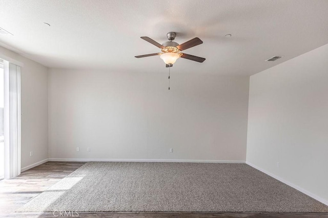 unfurnished room with light carpet, visible vents, baseboards, and ceiling fan