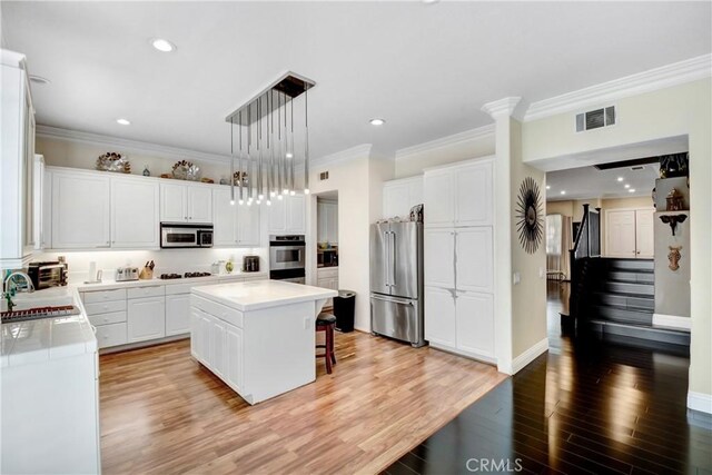 8345 Sunshine Ln, Riverside, CA 92508 - kitchen featuring a kitchen bar, visible vents, a sink, a center island, and stainless steel appliances