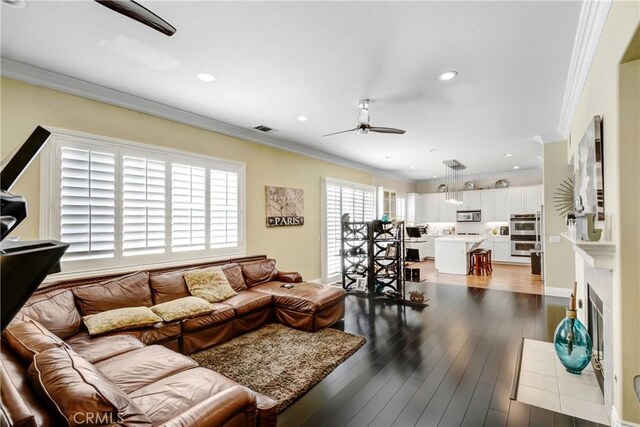 8345 Sunshine Ln, Riverside, CA 92508 - living room featuring a ceiling fan, visible vents, recessed lighting, dark wood-type flooring, and crown molding