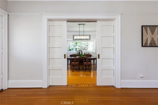 interior space featuring baseboards and wood finished floors