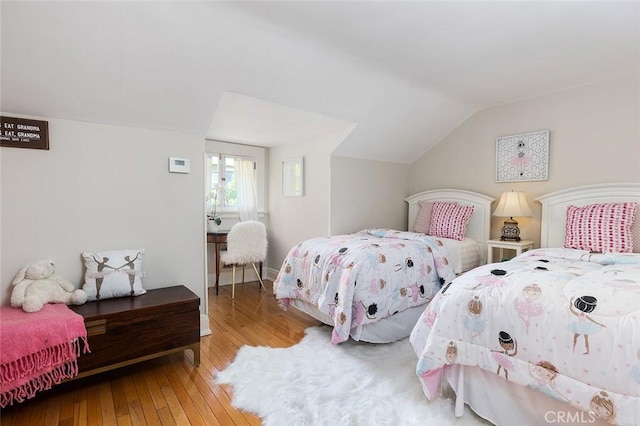 bedroom featuring hardwood / wood-style floors and lofted ceiling