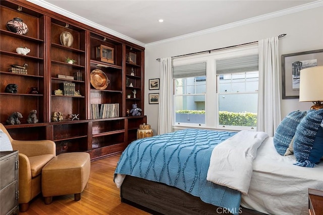 bedroom featuring crown molding and wood finished floors