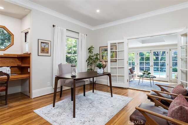 office space with crown molding, recessed lighting, light wood-style flooring, and french doors