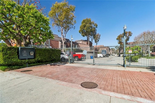view of gate featuring a residential view and fence