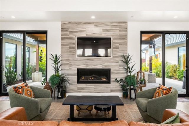living area with a fireplace, a healthy amount of sunlight, and recessed lighting