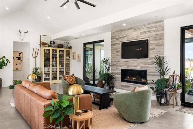 living room with high vaulted ceiling, a fireplace, ceiling fan, recessed lighting, and finished concrete floors