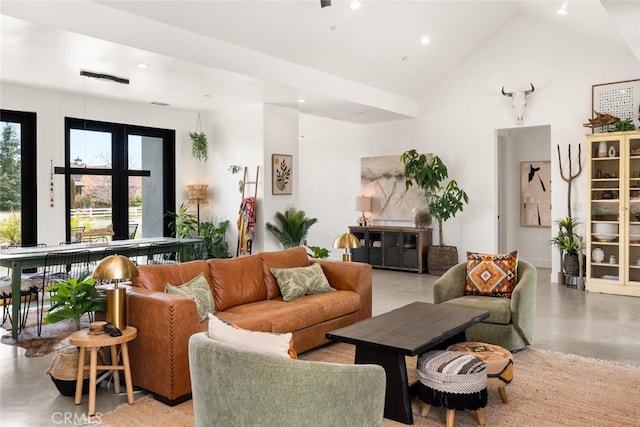 living area with high vaulted ceiling and recessed lighting