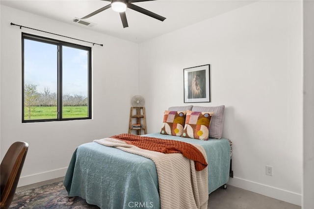 bedroom featuring baseboards, ceiling fan, and visible vents