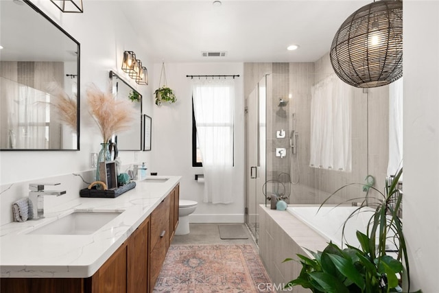 bathroom with toilet, a sink, a stall shower, and a bath