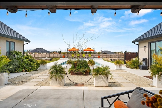 exterior space featuring a fenced in pool, a fenced backyard, and a patio area