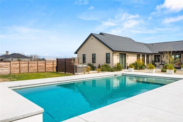 view of swimming pool with a fenced in pool, fence, and a patio area