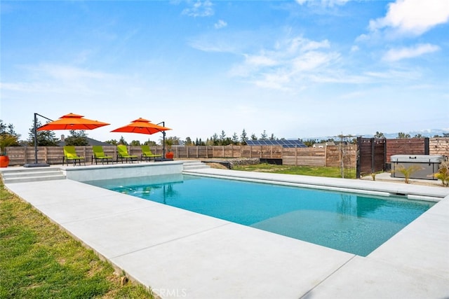 pool featuring fence and a patio area