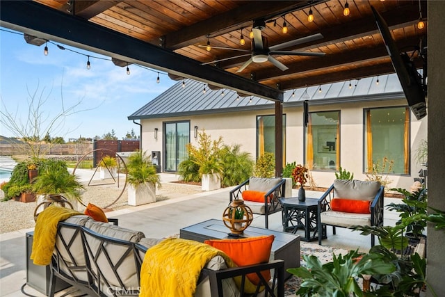 view of patio with an outdoor living space, fence, and a ceiling fan