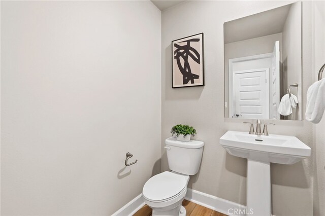19091 Azul Ln, Huntington Beach, CA 92648 - half bath featuring baseboards, wood finished floors, toilet, and a sink