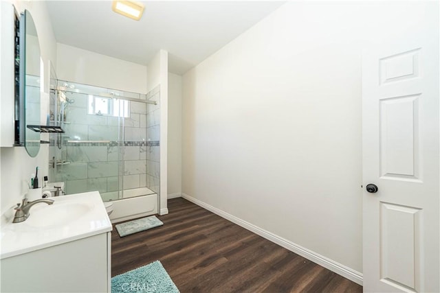 full bathroom featuring vanity, baseboards, an enclosed shower, and wood finished floors