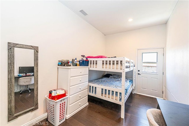 bedroom featuring visible vents and wood finished floors