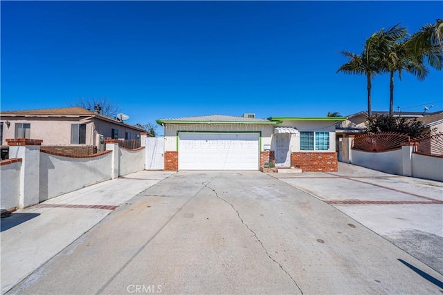 single story home with brick siding, concrete driveway, a garage, and fence
