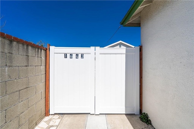 view of gate featuring fence