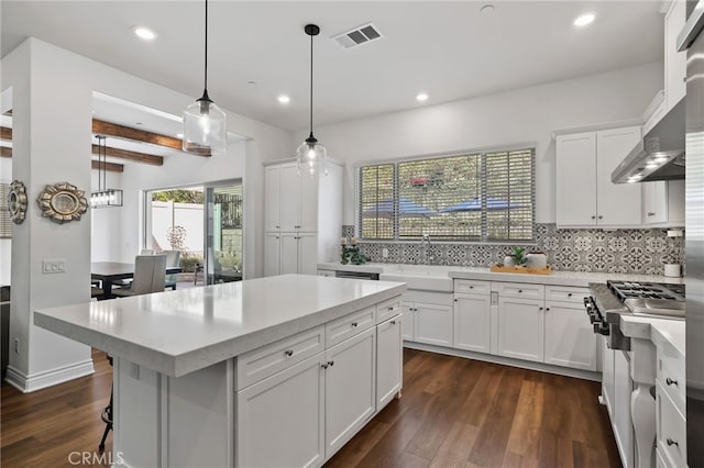 1711 Sonora Creek Ln, Lake Forest, CA 92610 - kitchen featuring tasteful backsplash, light countertops, dark wood-type flooring, visible vents, and a sink
